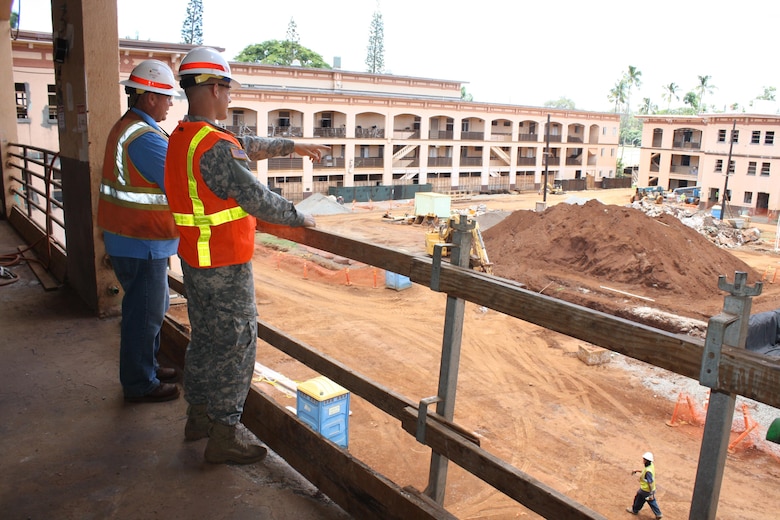 Cadet Calvin Kiesewetter (right) asks Army Corps of Engineers Construction Control Representative Joe Tribbey a question about the location of construction equipment at the Corps’ Quad B renovation project site.