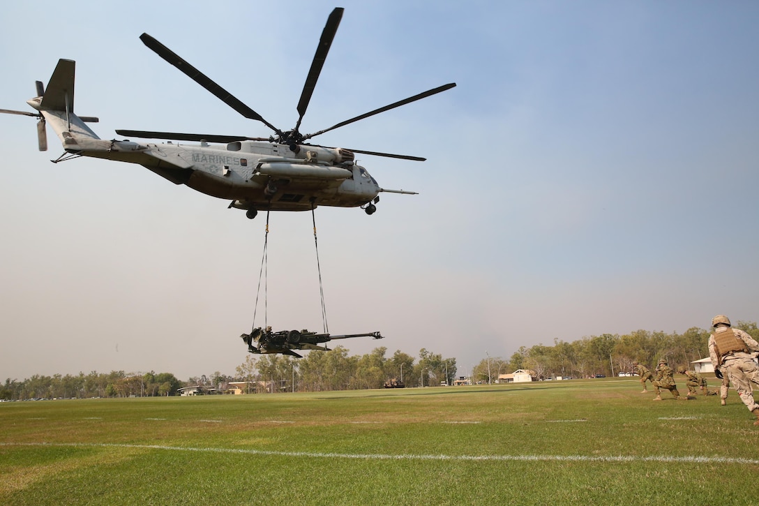 A U.S. Marine Corps CH-53E Super Stallion helicopter with Marine Heavy Helicopter Squadron 463, Marine Rotational Force – Darwin, conducts an external lift of an M777A2 lightweight 155 mm howitzer  Aug. 5, at Robertson Barracks, Palmerston, Northern Territory. The Marine pilots and aircrew, along with soldiers with 8th/ 12th Regiment, Royal Australian Artillery, 1st Brigade, Australian Army, Australian Defence Force, planned and conducted the external lift of the howitzer and familiarized both units with each other’s training procedures to enhance interoperability. The MRF-D six-month deployment demonstrates how the Marine Air-Ground Task Force is equipped and organized to carry out national objectives in cooperation with our international partners. 