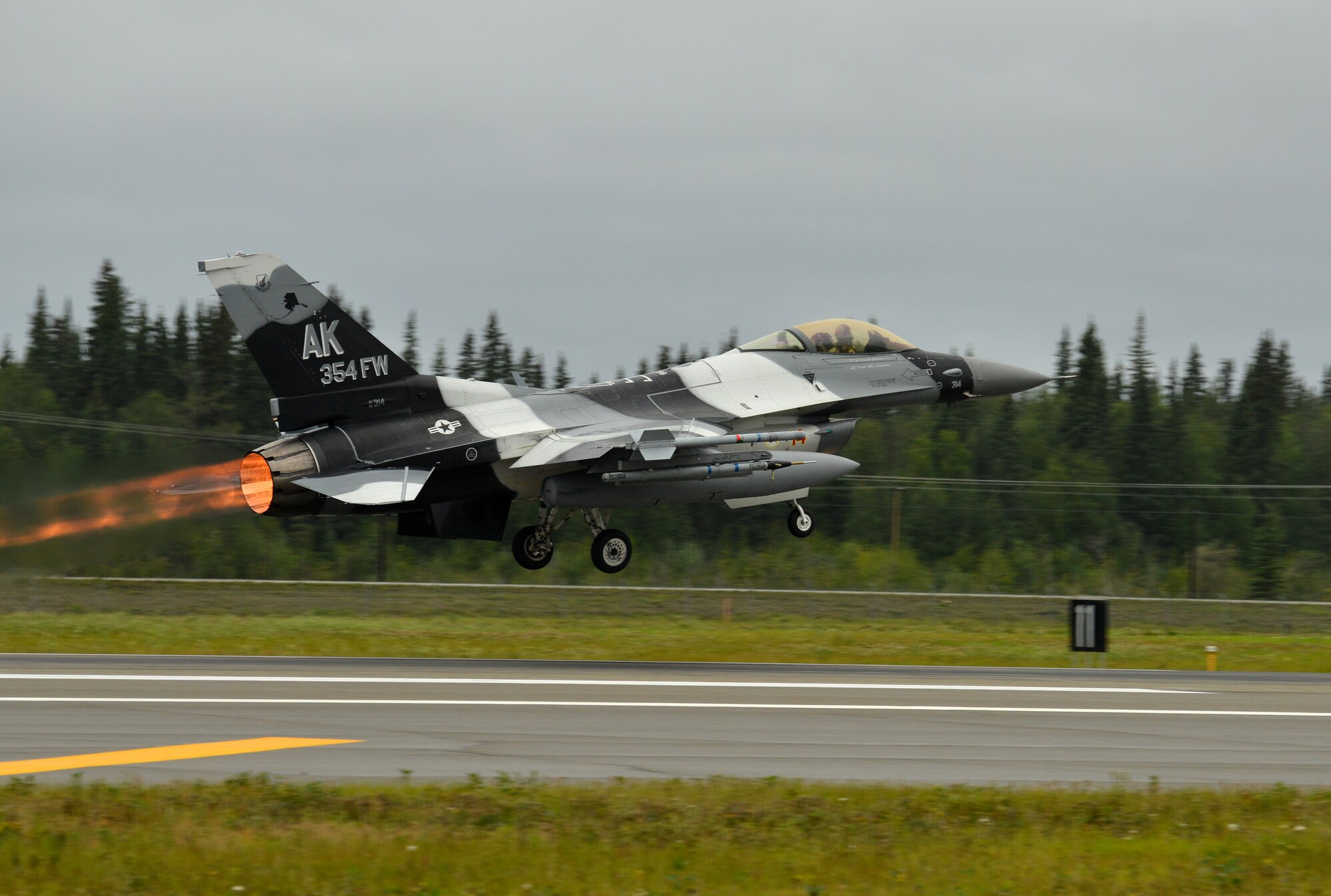 A U.S. Air Force F-16 Fighting Falcon assigned to the 18th Aggressor Squadron takes off from the Eielson Air Force Base, Alaska, flightline Aug. 10, 2015, as part of the first simulated combat sortie of RED FLAG-Alaska 15-3. The Aggressors are participating as opposing forces during this Pacific Air Forces commander-directed field training exercise for U.S. and partner nation forces, providing combined offensive counter-air, interdiction, close air support, and large force employment training in a simulated combat environment. (U.S. Air Force photo by Airman 1st Class Kyle Johnson/Released)