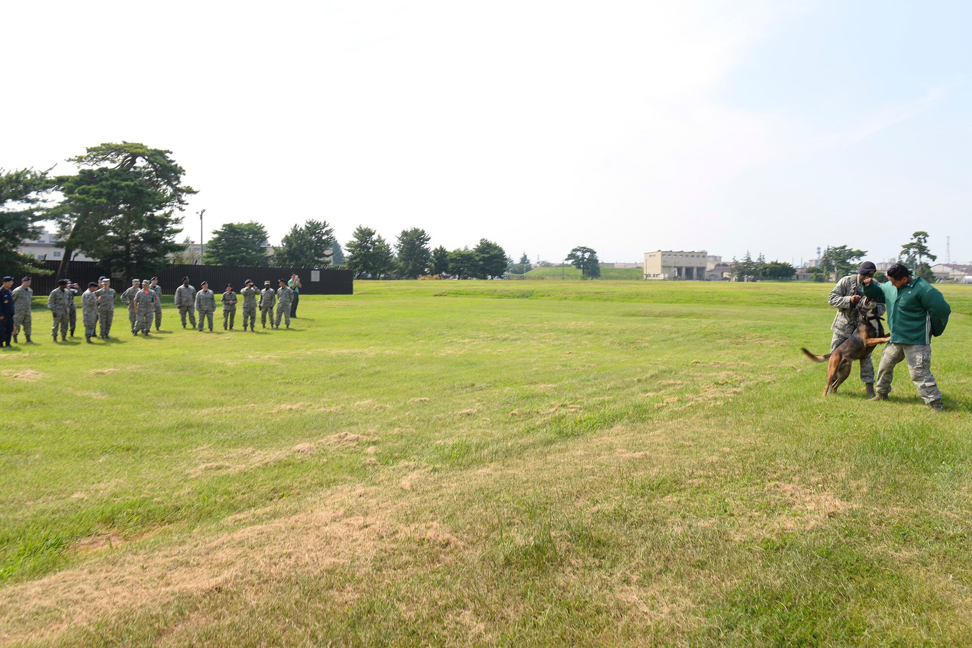 The 374th Security Forces Squadron canine unit displays military working dog effectiveness for U.S. Air Force Gen. Lori Robinson, Pacific Air Forces commander, at Yokota Air Base, Japan, Aug. 7, 2015. As part of her visit to Yokota, Robinson viewed several notable facilities, received briefings and assessed specific needs. (U.S. Air Force photo by Airman 1st Class Elizabeth Baker/Released)