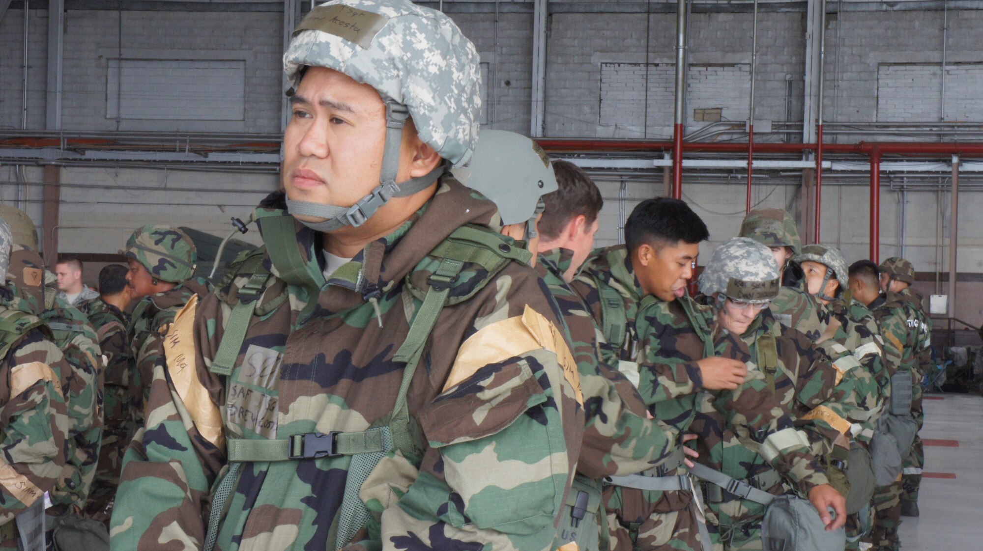 Airmen from the Hawaii Air National Guard cue up and wait for their small group hands on portion of Chemical Biological and Nuclear Environment survival training during the hands on portion of self-aid and buddy care training during August's unit training assembly, Aug. 9, 2015, Joint Base Pearl Harbor-Hickam. (U.S. Air National Guard Photo by Tech. Sgt. Andrew Jackson)