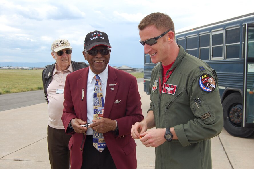 One of the last remaining Tuskegee Airmen, James Harvey III, visits with Capt. Danny Hull, pilot, 120th Fighter Squadron, while watching the F-16s land at Buckley AFB. Members of the 8th Air Force Historical Society, including several WWII veterans, visited the 140th Wing on July 31. (US Air National Guard photo by Capt. Kinder Blacke)