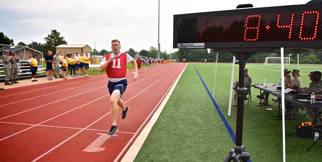 Tech. Sgt. Anthony Young, crew chief with the 932nd Airlift Wing, is cheered on as he finishes his one mile and a half run just under nine minutes, Aug. 9, 2015 at Scott Air Force Base, Illinois.  Young has been playing soccer for over 15 years and contributes his consistent run times to the quick sprinting he does during a soccer match.  Young had the fastest  run of the day.  (U.S. Air Force photo/Tech. Sgt. Christopher Parr)