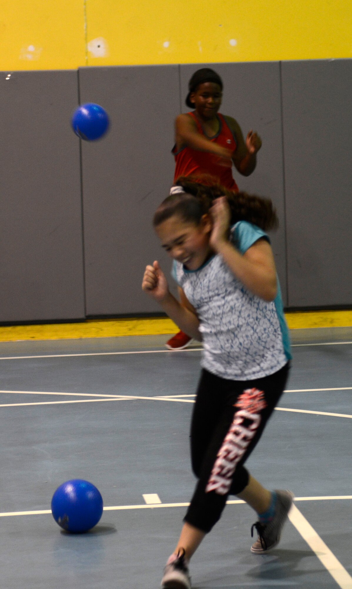 Students play dodgeball during a Back-to-School BBQ event hosted by the McConnell Youth Center, Aug. 7, 2015, at McConnell Air Force Base, Kan. Dodgeball was one of several events that children had available to them during the BBQ, including ping pong, video games and pool. (U.S. Air Force photo by Senior Airman Trevor Rhynes)