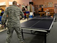 Master Sgt. Travis Craig, 22nd Force Support Squadron and 22nd Air Refueling Wing Director of Staff 1st Sgt., plays ping pong with his daughter, Aug. 7, 2015, at McConnell Air Force Base, Kan. The McConnell Youth Center hosted a Back-to-School BBQ as a way to wrap the summer up and begin a new school year on a good note. (U.S. Air Force photo by Senior Airman Trevor Rhynes)