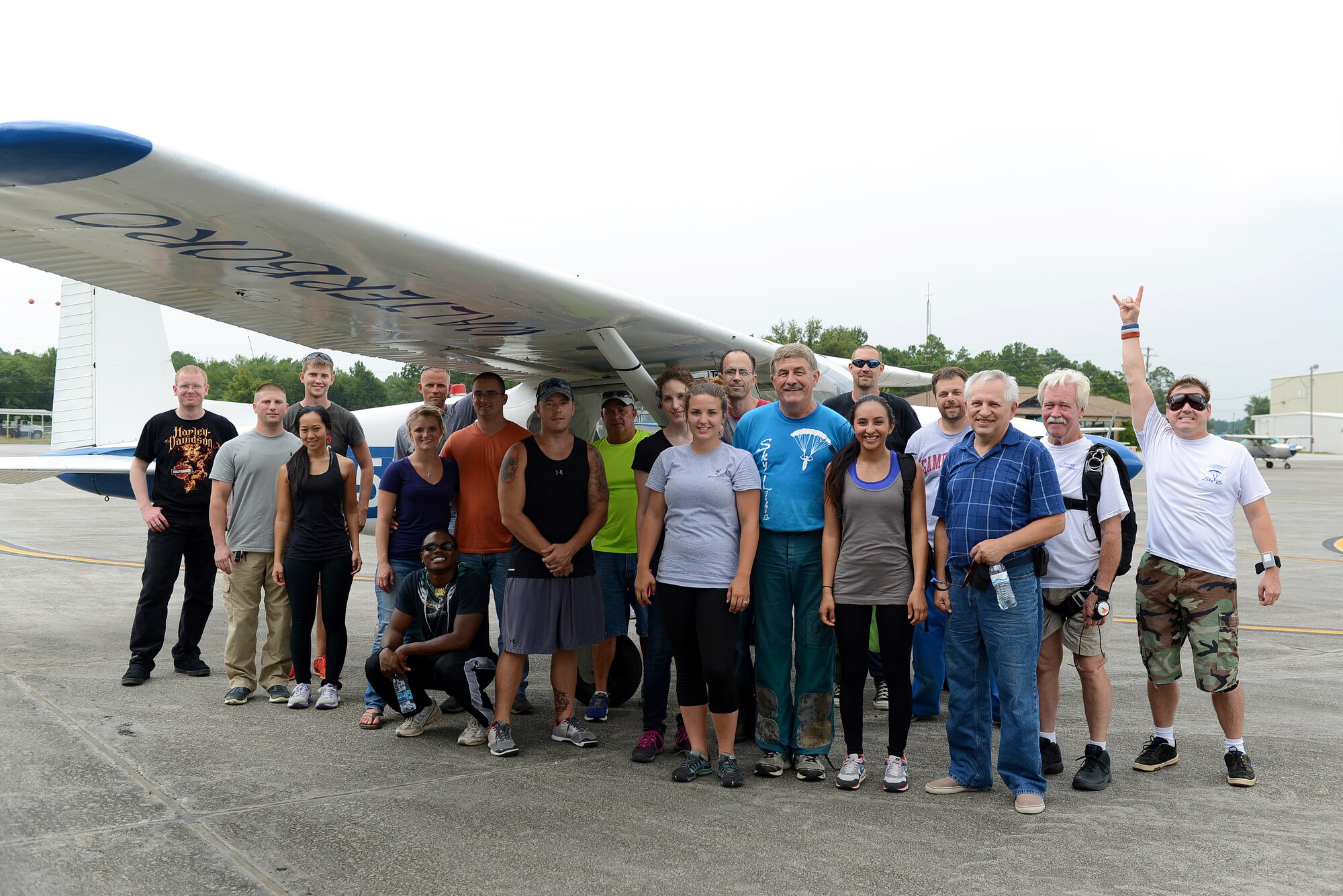 Team Shaw members gather for a photo with the skydiving facility members during a 20th Force Support Squadron skydiving event at Walterboro, S.C., Aug. 1, 2015. The 20th FSS puts on affordable events to help build the morale and welfare of Team Shaw members. (U.S. Air Force photo by Senior Airman Diana M. Cossaboom/Released)