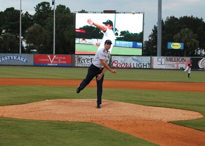 Captain Gary Tomasulo, United States Coast Guard Sector Charleston commander, throws out the first pitch at the Charleston RiverDogs baseball game honoring the U.S. Coast Guard’s 225th birthday on August 8, 2015. Over the past two and a quarter centuries the Coast Guard missions have grown from enforcing revenue laws to ensuring maritime safety, security and stewardship on the U.S. coastal shores and across the globe. The RiverDogs lost to Savannah 8 – 1. (Charleston RiverDogs photo/Vin Duffy)