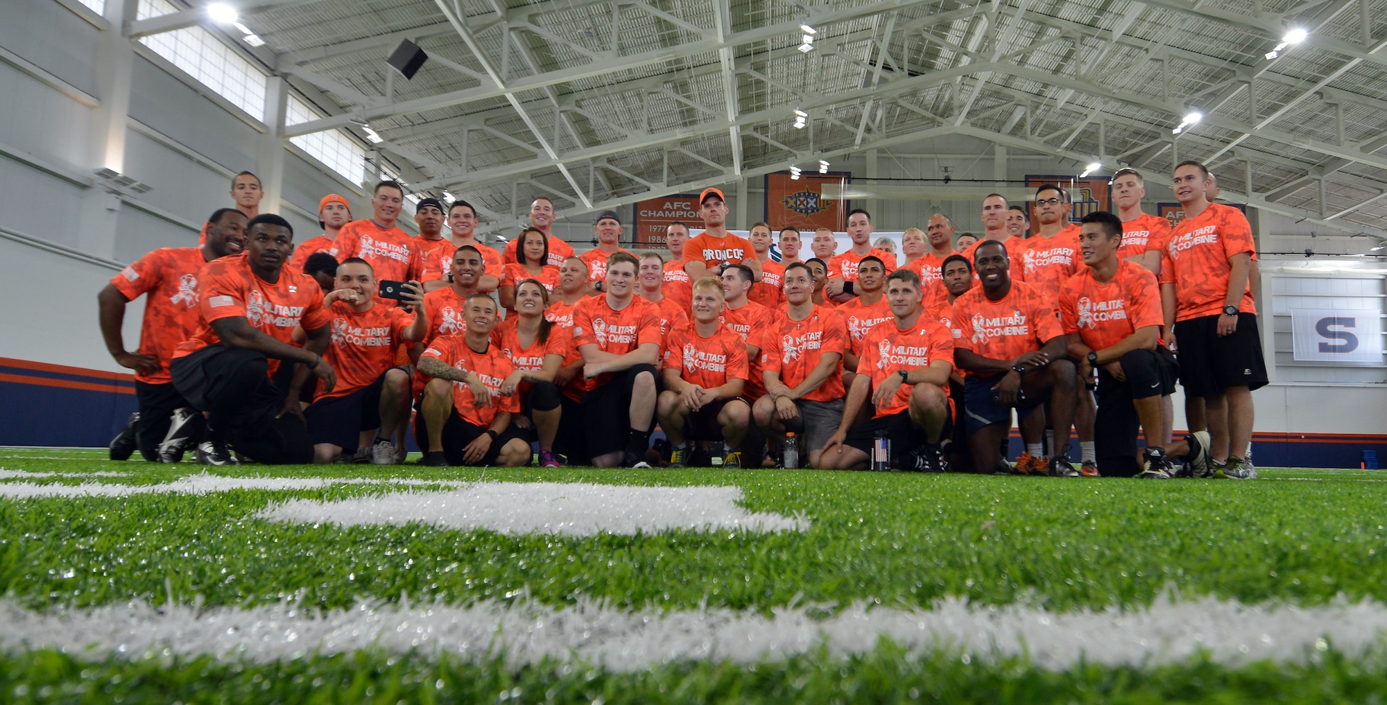 Participants from the Denver Broncos Military Combine take a group photo after running training drills Friday, August 7, 2015, at the Dove Valley Fieldhouse in Englewood, Colorado. The military combine provided participants from Schriever, Peterson and Buckley Air Force Bases as well as Fort Carson the opportunity to train like NFL players under the direction of Denver Broncos’ football-greats K.C. Jones and Mark Cooper. (U.S. Air Force photo/Staff Sgt. Debbie Lockhart)