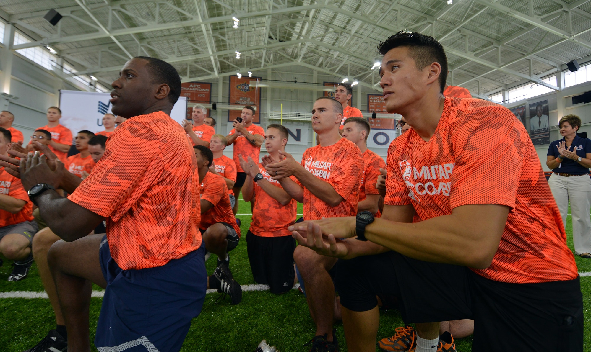 Participants from the Denver Broncos Military Combine take a knee after running some training drills Friday, August 7, 2015, at the Dove Valley Fieldhouse in Englewood, Colorado. Eight Airmen from Schriever Air Force base trained like National Football League players during the USAA sponsored event. (U.S. Air Force photo/Staff Sgt. Debbie Lockhart)
