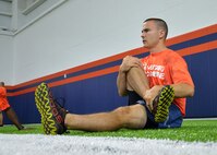 First Lt. Matthew Neeld, 22nd Space Operations Squadron crew commander, stretches before participating in the Denver Broncos Military Combine Friday, August 7, 2015, at the Dove Valley Fieldhouse in Englewood, Colorado. The military combine provided participants from Schriever, Peterson and Buckley Air Force Bases as well as Fort Carson the opportunity to train like NFL players under the direction of Denver Broncos’ football-greats K.C. Jones and Mark Cooper. (U.S. Air Force photo/Staff Sgt. Debbie Lockhart)