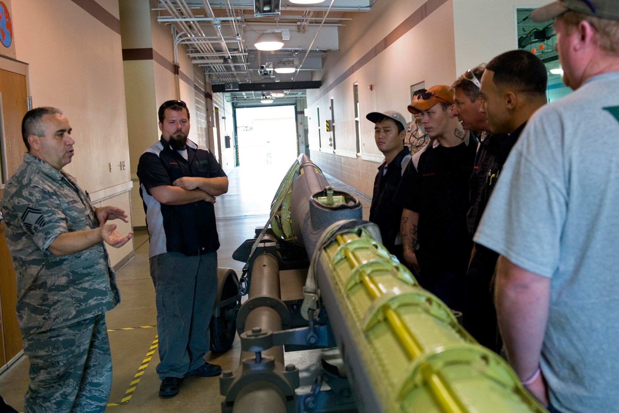 Senior Master Sgt. Douglas Stogsdill, 434th Maintenance Squadron fabrications flight chief, explains the inner workings of a boom from a KC-135R Stratotanker to a group of Kokomo, Ind., Ivy Tech students and staff at Grissom Air Reserve Base, Ind., July 22, 2015. During the tour the group visited Grissom's fabrication shop in addition to a KC-135R static display. (U.S. Air Force photo/Tech. Sgt. Benjamin Mota)