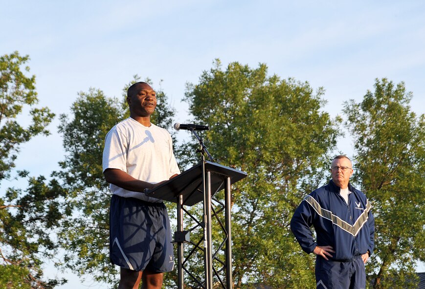 Col. Rodney Lewis, 319th Air Base Wing commander, delivers a pep talk before kicking off his first base-wide wing run on Grand Forks Air Force Base, N.D., Aug. 6, 2015. Airmen from all squadrons participated in the two-mile run to promote fitness and build camaraderie. (U.S. Air Force photo by Airman 1st Class Bonnie Grantham/Released)