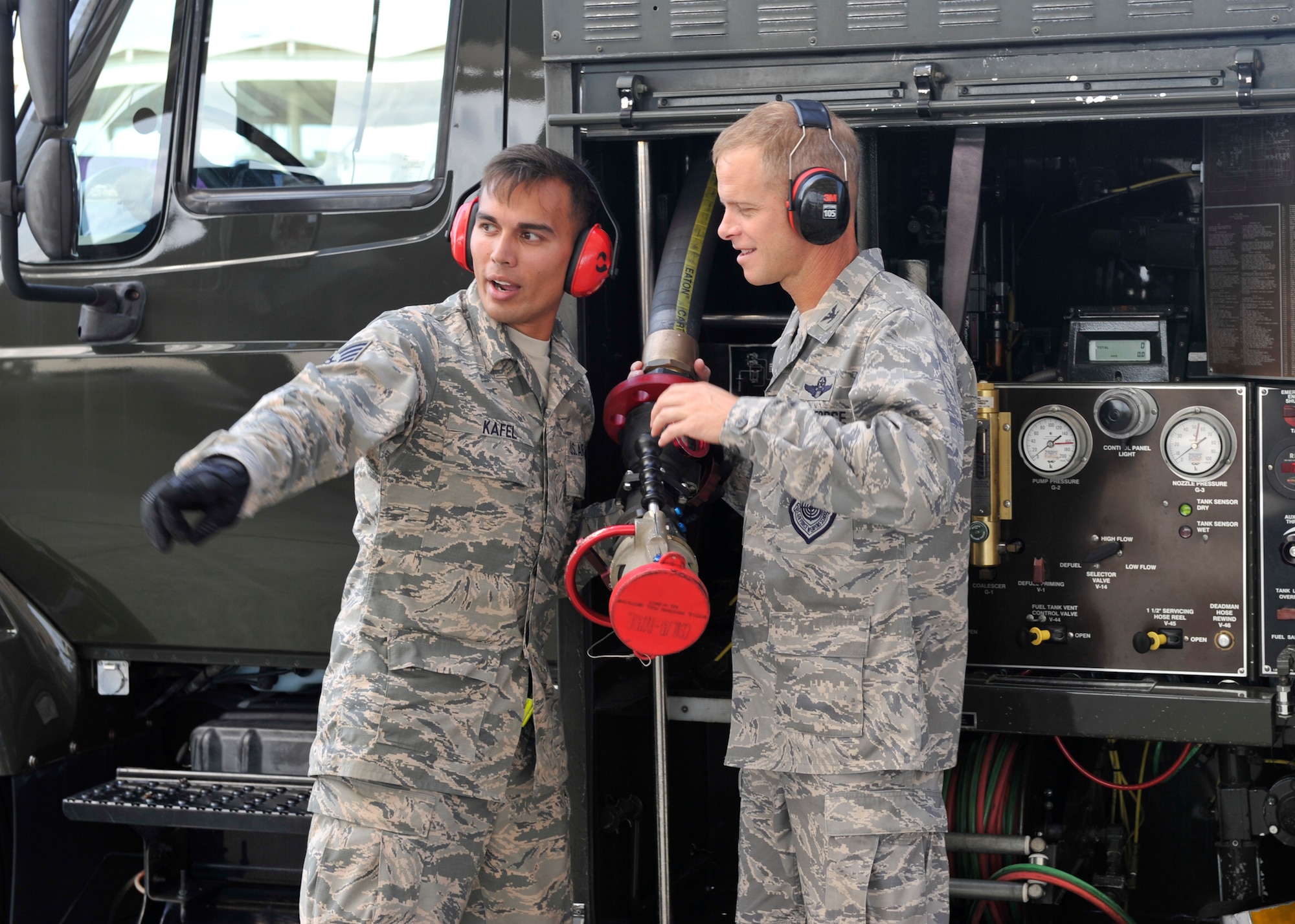 Staff Sgt. Christian Kafel (left), 325th Logistics Readiness Squadron fuels distribution supervisor, explains to Col. Derek C. France, 325th Fighter Wing commander, the proper technique of using a fuels hoes Aug. 7 at the Tyndall flighline. Kafel had the opportunity to highlight his career-field and show the commander some of his unit’s daily operations. (U.S. Air Force photo by Airman 1st Class Sergio A. Gamboa/Released) 