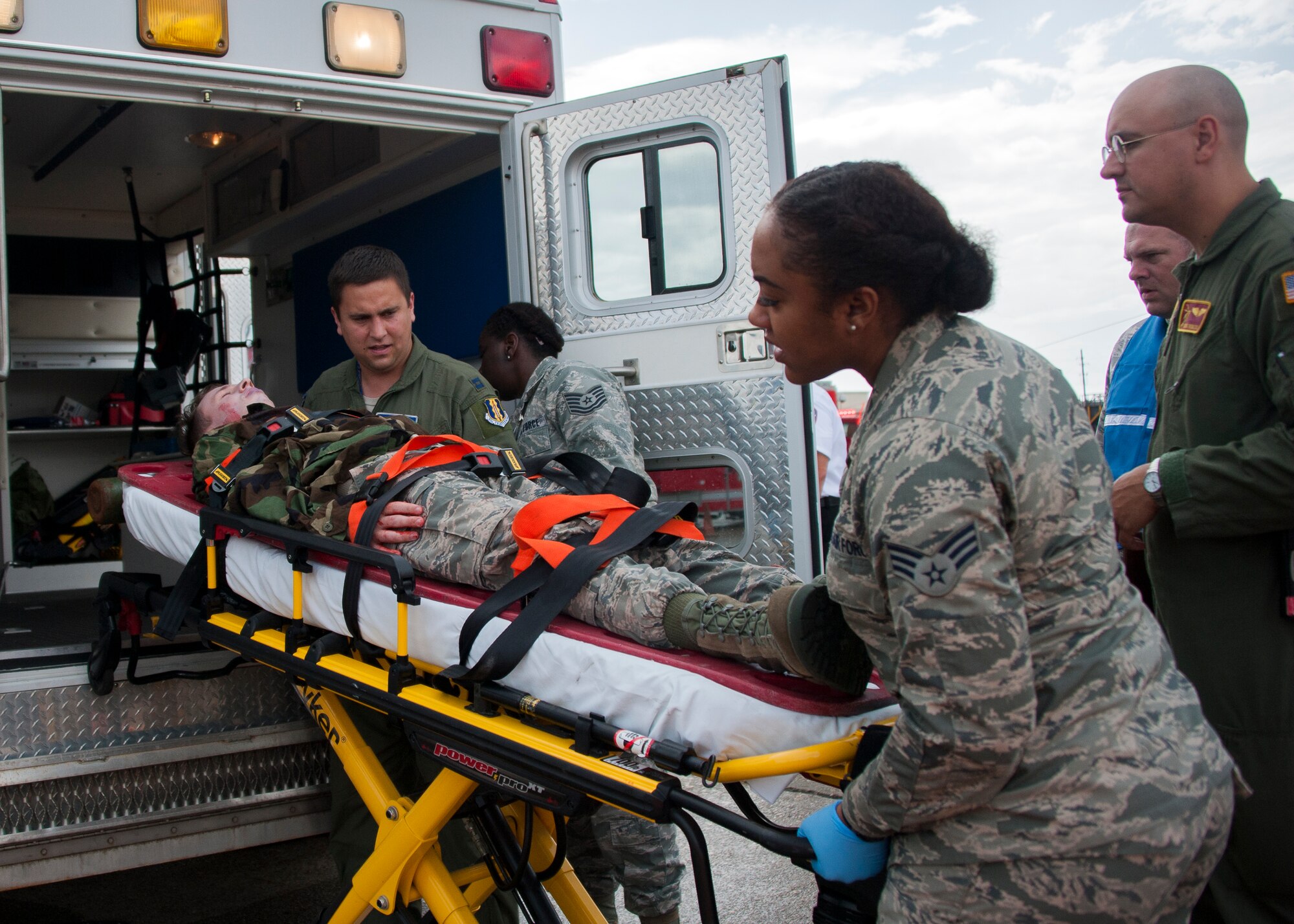 Eglin medical personnel lift an injured Airman into an ambulance for treatment during a simulated aircraft hijacking scenario as part of the 96th Test Wing’s force protection condition exercise Aug. 6 at Eglin Air Force Base, Fla.  The FPCON exercise tested the base’s first responders’ rescue skills while the simulated hijacker was apprehended and the injured were moved to safety for treatment. (U.S. Air Force photo/Ilka Cole)