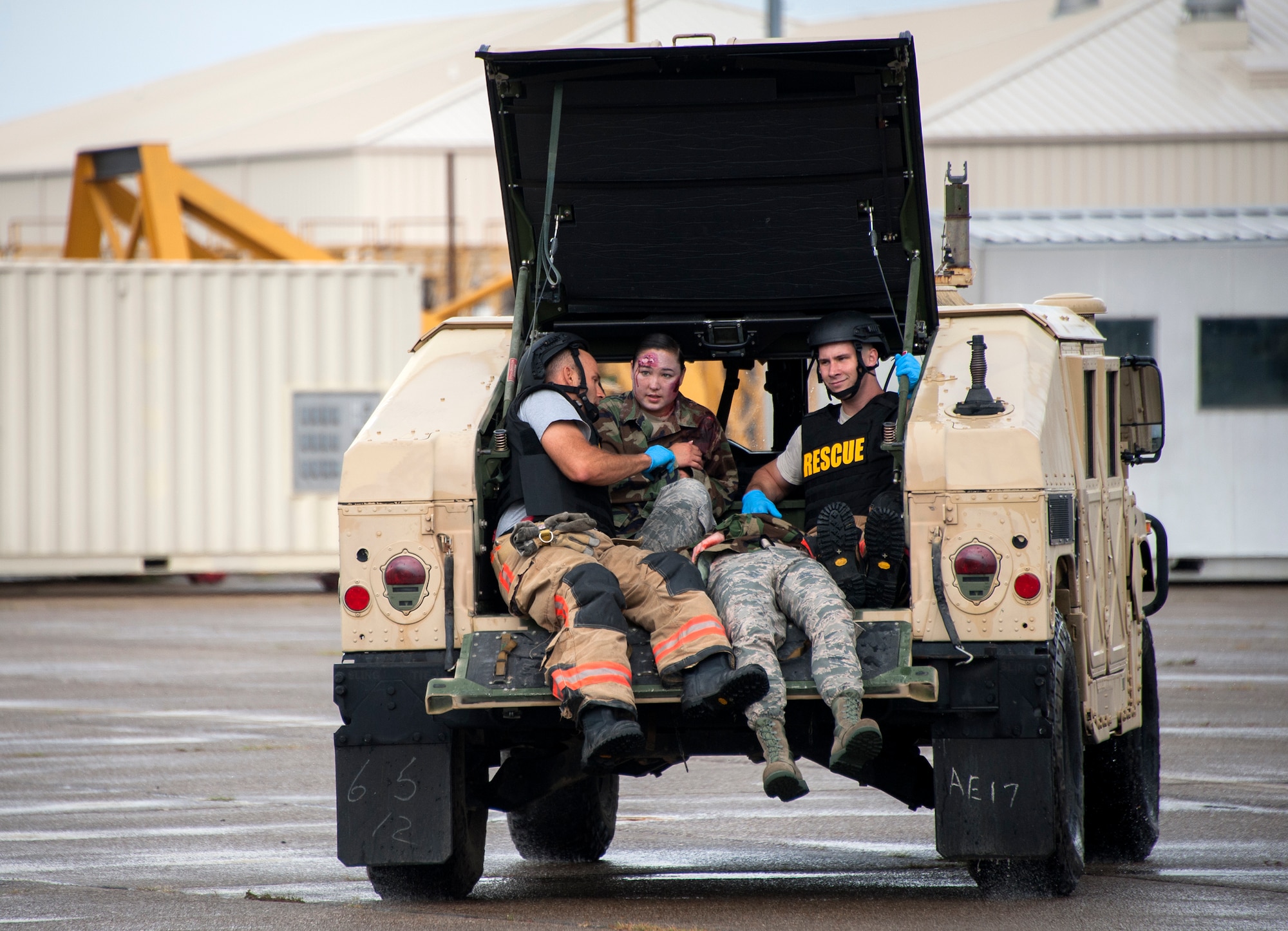 Eglin fire and rescue personnel aide and accompany the injured to safety during a simulated aircraft hijacking scenario as part of the 96th Test Wing’s force protection condition exercise Aug. 6, 2015 at Eglin Air Force Base, Fla.  The FPCON exercise tested the base’s first responders’ rescue skills while the simulated hijacker was apprehended and the injured were moved to safety for treatment. (U.S. Air Force photo/Ilka Cole)