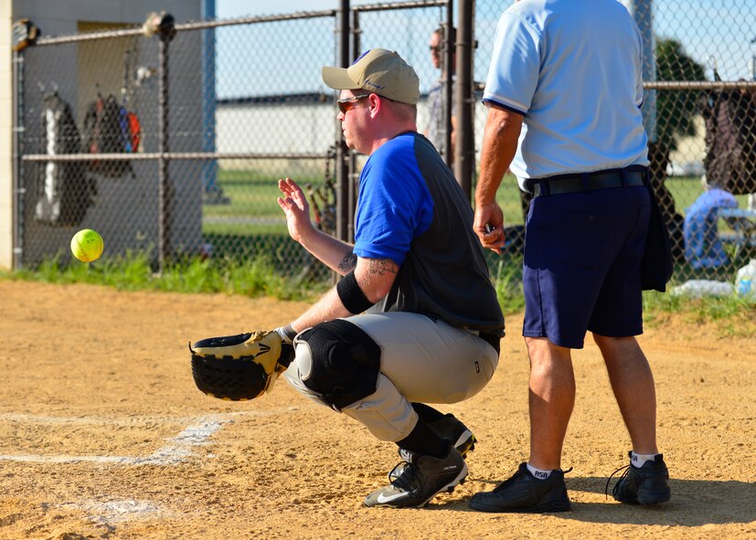 Patrick McGee, 436th Security Forces Squadron catcher, prepares to catch a wild pitch bare handed during an intramural softball game against the 436th Aircraft Maintenance Squadron Aug. 3, 2015, at the softball field on Dover Air Force Base, Del. The 436th SFS won the rematch 8-7 after losing to the 436th AMXS 12-18 in their first meeting of the season. (U.S. Air Force photo/Airman 1st Class William Johnson)
