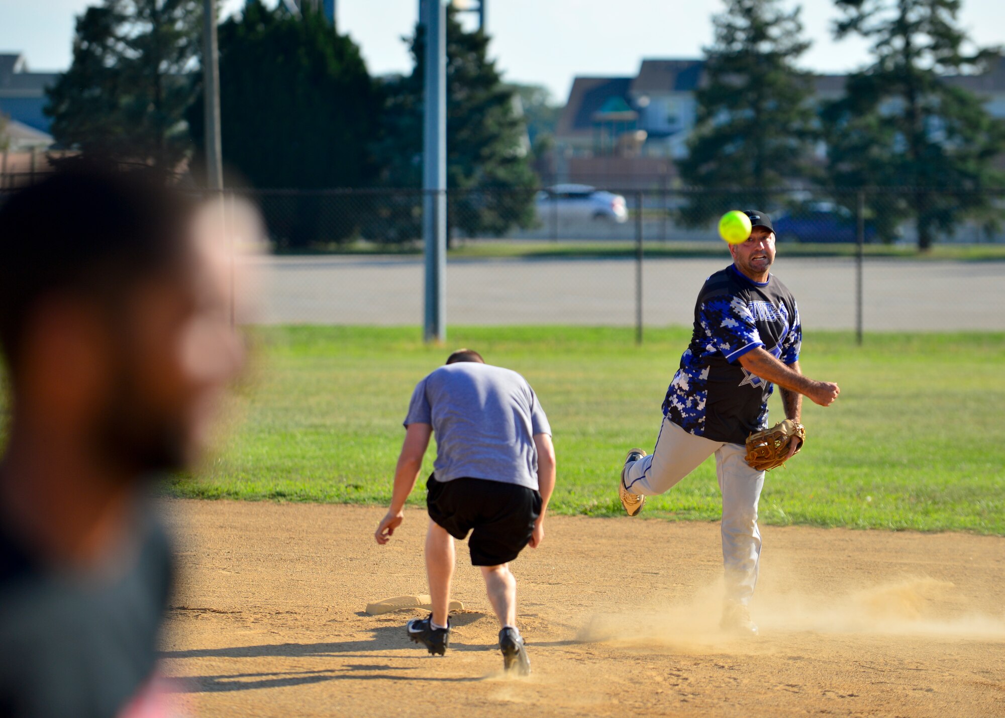 Kenneth Bancroft, 436th Security Forces Squadron player-coach, throws a softball to first base to turn a double play during an intramural softball game against the 436th Aircraft Maintenance Squadron Aug. 3, 2015, at the softball field on Dover Air Force Base, Del. The 436th SFS defeated the 436th AMXS 8-7 and are still eligible to make the playoffs. (U.S. Air Force photo/Airman 1st Class William Johnson)