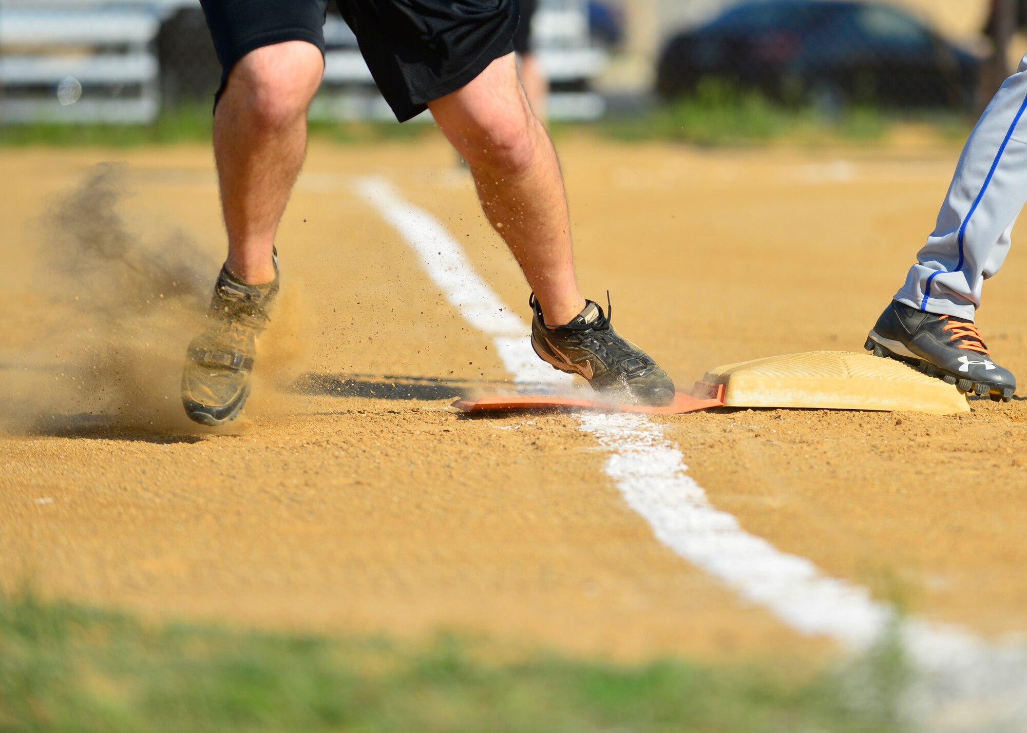 Adam Paini, 436th Security Forces Squadron pitcher, sprints through first base after hitting a line drive during an intramural softball game against the 436th Aircraft Maintenance Squadron Aug. 3, 2015, at the softball field on Dover Air Force Base, Del. The 436th SFS won their last regular season game 8-7, and remain in the running for the playoffs. (U.S. Air Force photo/Airman 1st Class William Johnson)