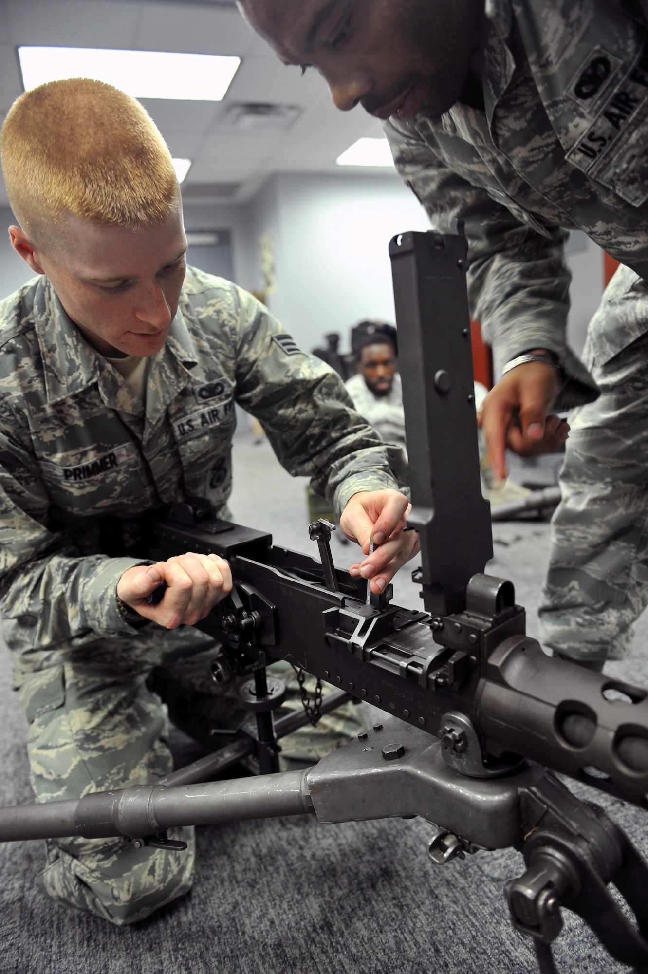 ALTUS AIR FORCE BASE, Okla. – U.S. Air Force Senior Airman Bradley Primmer, 82nd Security Forces Squadron combat arms training and maintenance instructor from Sheppard Air Force Base, Texas, checks the timing on an M2 machine gun during the classroom portion of a weapons systems instructor certification course inside the Altus AFB CATM classroom, Aug. 6, 2015. Adjusting the timing on the M2 weapons system ensures the weapon will properly feed munitions into the barrel and ensures weapon safety for the operator. (U.S. Air Force photo by Senior Airman Dillon Davis/Released)
