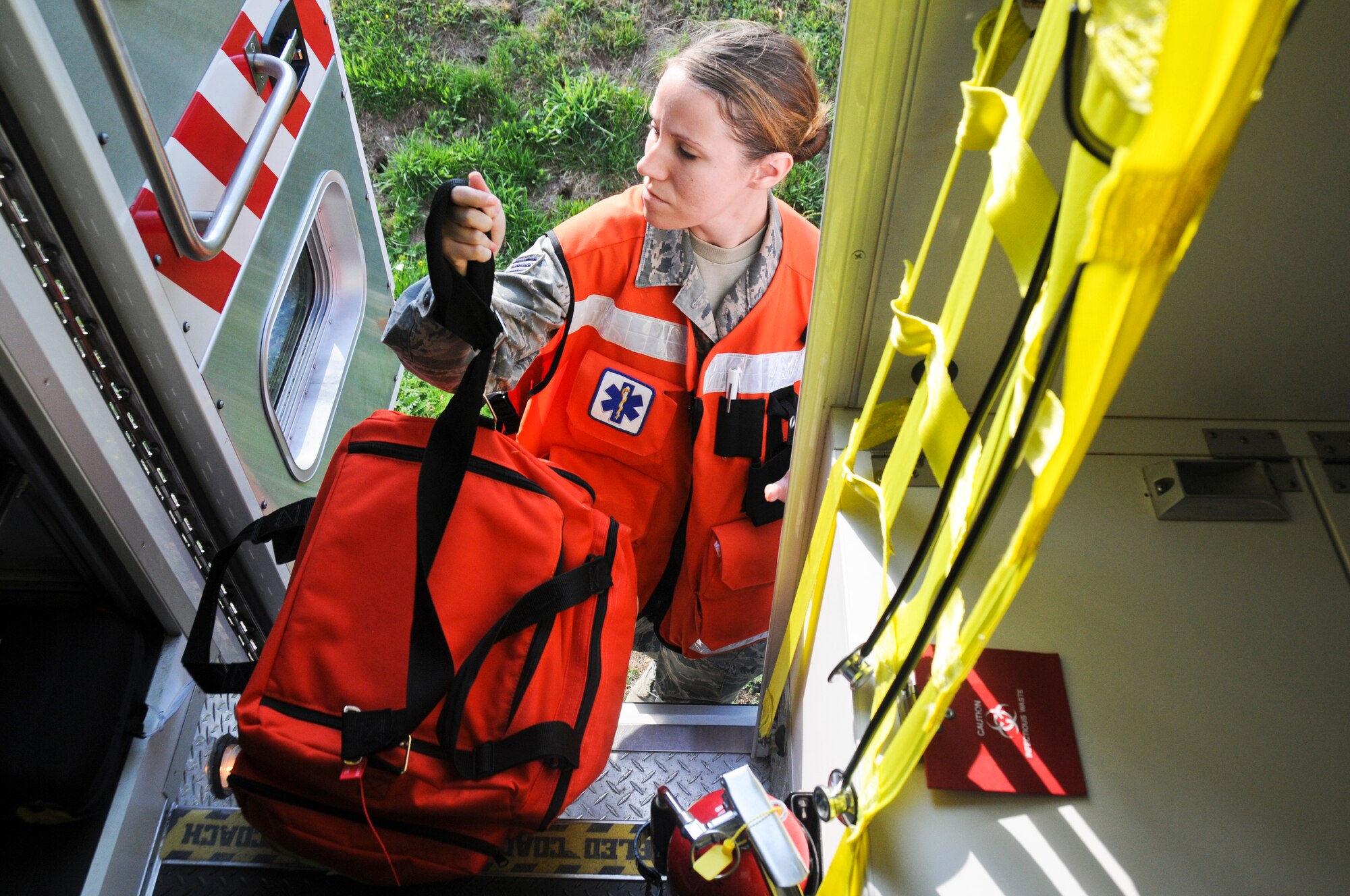 A picture of U.S. Air Force Senior Airman Melissa Seel, an aerospace medical technician from the New Jersey Air National Guard's 177th Medical Group, grabbing her emergency medical bag before heading to the scene of a simulated fuel spill.