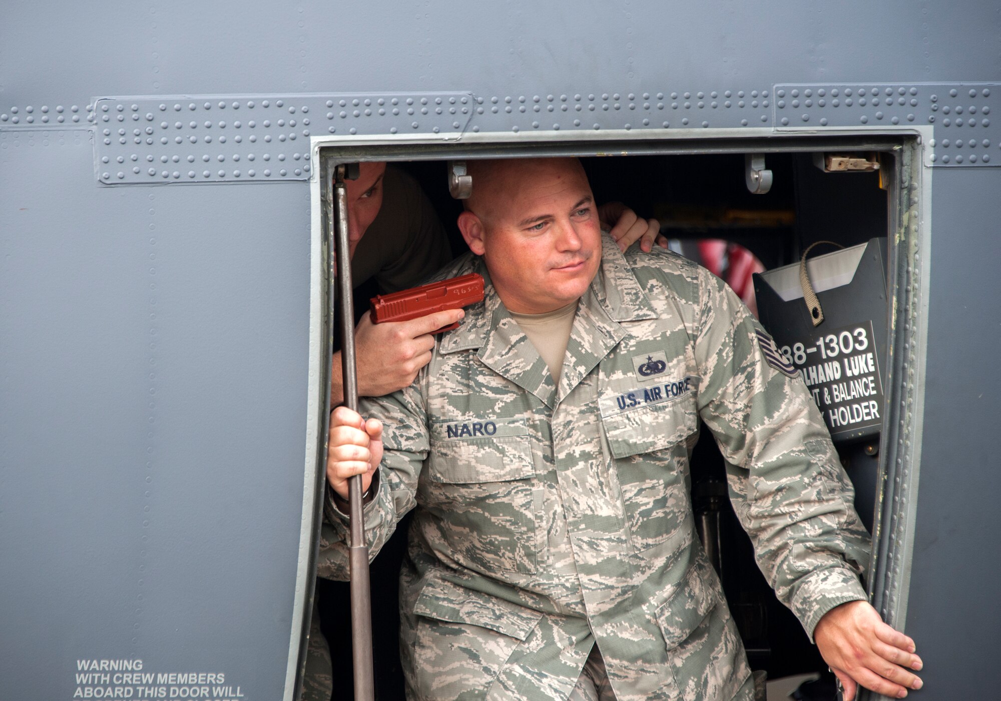 Tech. Sgts. Christopher Cope and Daniel Naro, both of the 96th Logistics Readiness Squadron, participate in a simulated aircraft hijacking scenario during the 96th Test Wing’s force protection condition exercise Aug. 6 at Eglin Air Force Base, Fla.  The FPCON exercise tested the base’s first responders’ rescue skills while the simulated hijacker was apprehended and the injured were moved to safety for treatment. (U.S. Air Force photo/Ilka Cole)