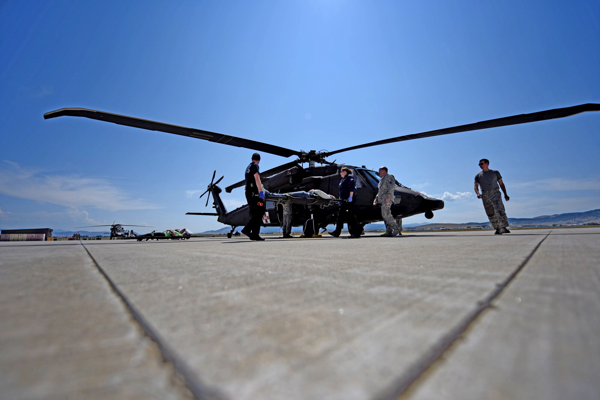 A Blackhawk helicopter specially fitted to medivac injured patients drops off four simulated casualties of the Major Accident Response Exercise at a virtual triage center in Helena, Mont., Aug 10. During the exercise, two UH-1N Huey helicopters from Malmstrom, two UH-60 Black Hawks and a CH-47 Chinook helicopter from the Army National Guard’s 1-189th General Support Aviation Battalion airlifted 42 simulated patients to complete their portion of the event. (U.S. Air Force photo/Airman 1st Class Collin Schmidt)