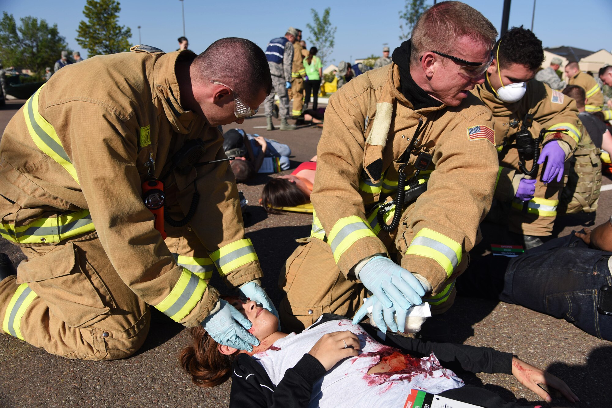 Emergency response personnel from Malmstrom Air Force Base care for a simulated patient during a Major Accident Response Exercise Aug. 10. The exercise was implemented to evaluate how Airmen on base could organize and execute a massive casualty response while coordinating with multiple agencies across the state of Montana. (U.S. Air Force photo/Airman 1st Class Collin Schmidt)
