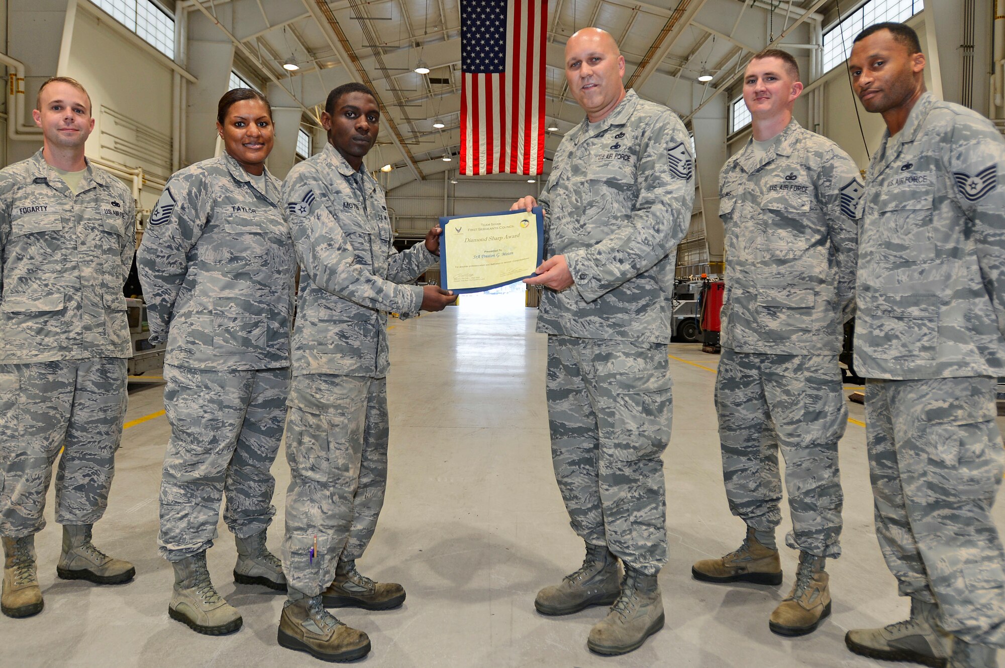 U.S. Air Force Senior Airman Preston Moten, 20th Equipment Maintenance Squadron aerospace ground equipment journeyman, is presented a Diamond Sharp Award by the Team Shaw First Sergeants Council at Shaw Air Force Base, S.C., Aug. 6, 2015. Moten received the award for his professionalism and dedication to service. (U.S. Air Force photo by Senior Airman Jensen Stidham/Released) 