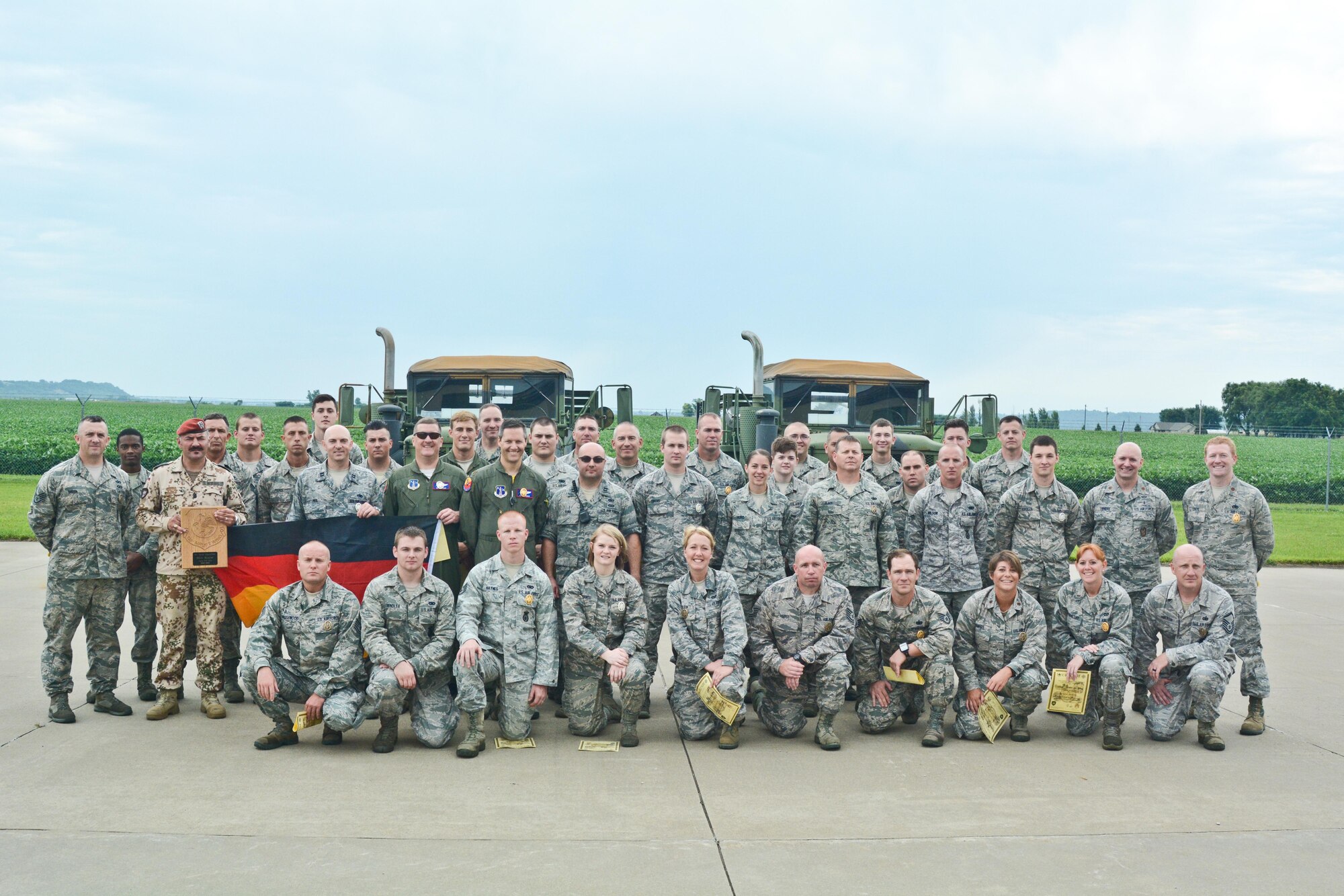 Airman from the 139th Airlift Wing, Missouri Air National Guard, are awarded the German Armed Forces Proficiency Badge after competing in physical training challenges at Rosecrans Air National Guard Base, St. Joseph, Mo. August 8, 2015.  The competition, administered by Sgt. Maj. Mike Kitzler, German liaison officer at Fort Leavenworth, KS, included sprints, flexed arm hang, 1000-meter run, 100-meter swim in uniform, pistol marksmanship, and ruck march.(U.S. Air National Guard photo by: Senior Airman Patrick P. Evenson/Released)