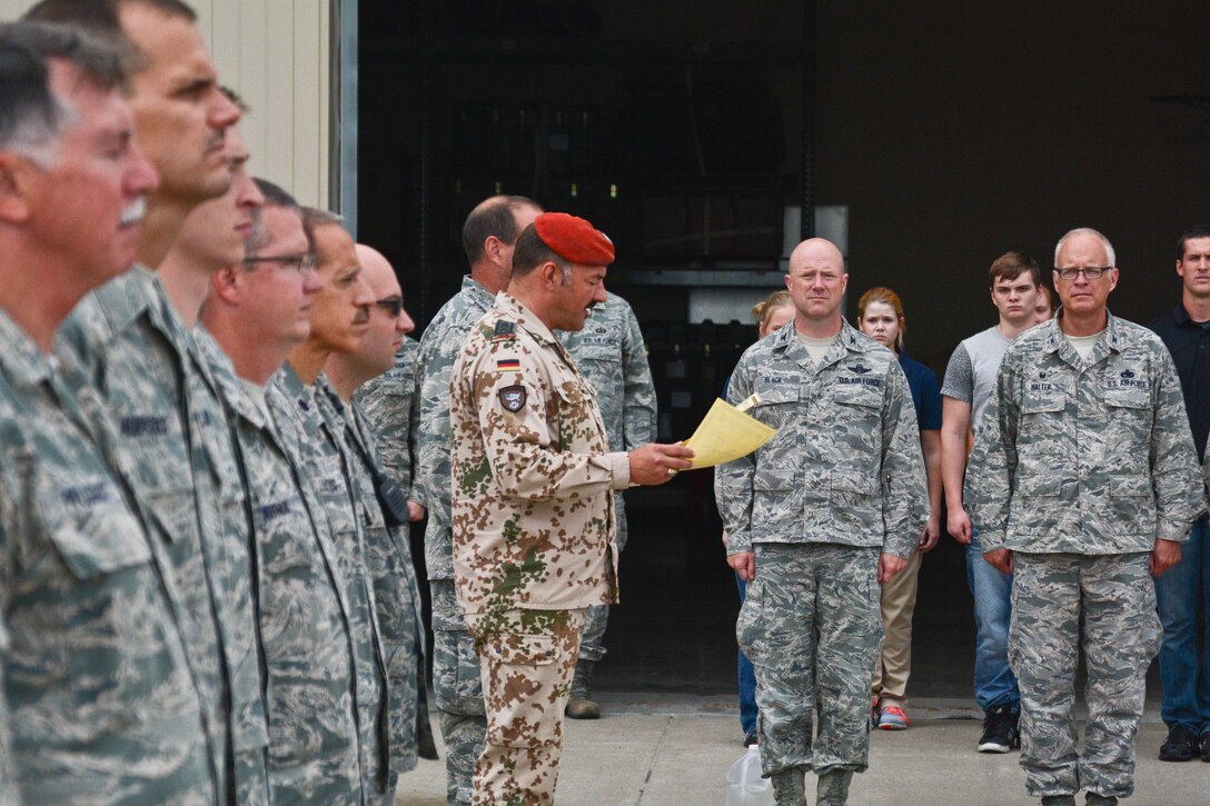 Airman from the 139th Airlift Wing, Missouri Air National Guard, are awarded the German Armed Forces Proficiency Badge after competing in physical training challenges at Rosecrans Air National Guard Base, St. Joseph, Mo. August 8, 2015.  The competition, administered by Sgt. Maj. Mike Kitzler, German liaison officer at Fort Leavenworth, KS, included sprints, flexed arm hang, 1000-meter run, 100-meter swim in uniform, pistol marksmanship, and ruck march.(U.S. Air National Guard photo by: Senior Airman Patrick P. Evenson/Released)
