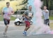 Senior Master Sgt. Christopher McMullin (#50), 53rd Air Traffic Control Squadron, and Senior Airman Skyler Odom (#69), 52nd Combat Communications Squadron, run through a color station during the Diversity 5K Color Run, Aug. 7, 2015.  The event was hosted by the Robins Diversity Council and about 80 runners and 30 volunteers got together to make this event a fun filled recognition of the differences in people's cultures.  (U.S. Air Force photo by Misuzu Allen)