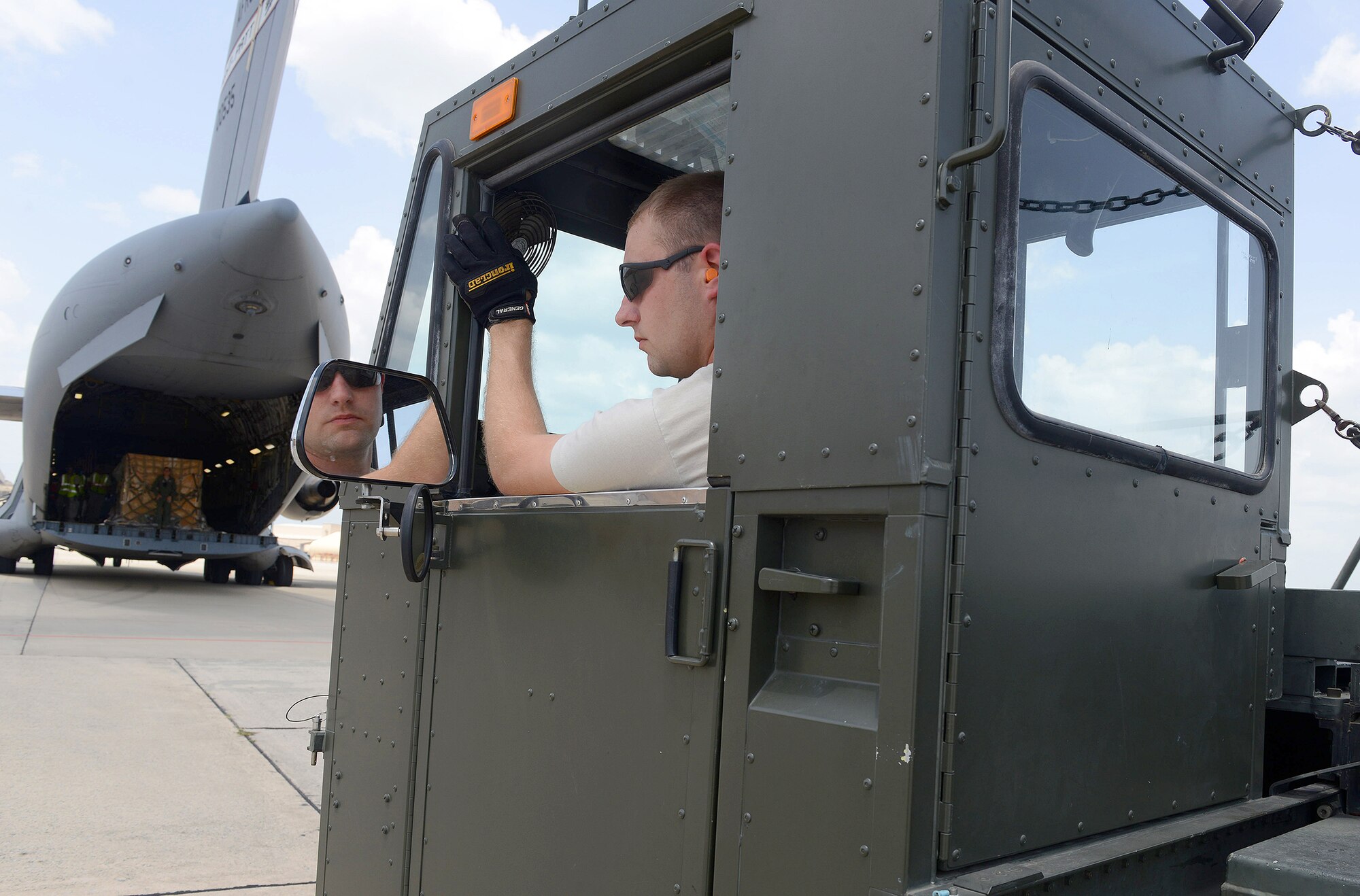 Staff Sgt. Clinghton Smith, 78th Logistics Readiness Squadron air cargo specialist, positions a K-Loader behind a C-17 Globemaster in preparation for an off-load. With the capability to carry a maximum of 18 master pallets or a mix of palletized cargo and vehicles, C-17 aircraft play a critical role in mission readiness. (U.S. Air Force photo by Tommie Horton)
 
