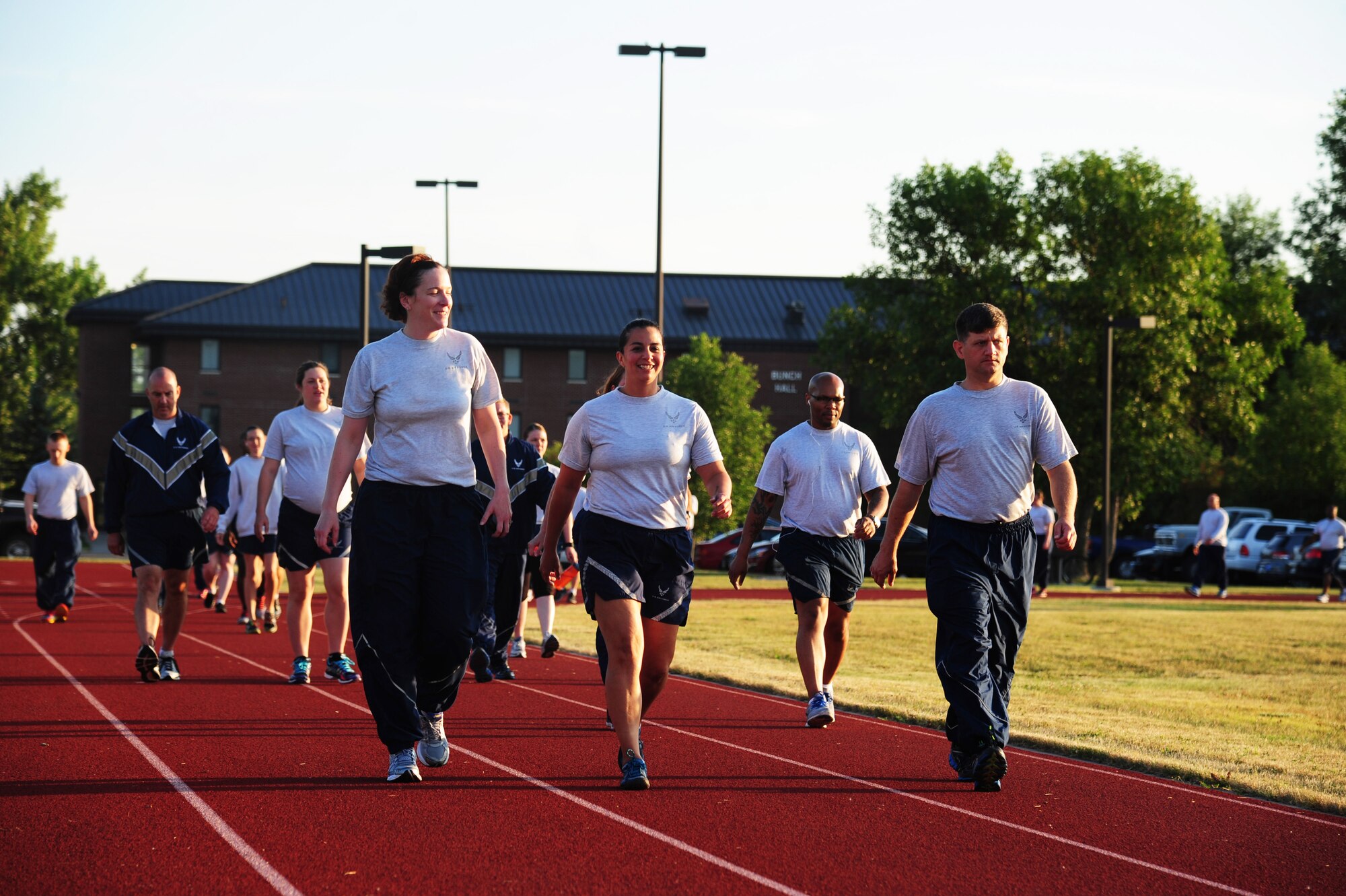Grand Forks Airmen walk the track during a wing run event August 6, 2015, on Grand Forks Air Force Base, N.D. Airmen who were unable to participate in the two-mile wing run because of a fitness waiver were able to walk laps as an alternative. (U.S. Air Force photo by Airman 1st Class Ryan Sparks/released)
