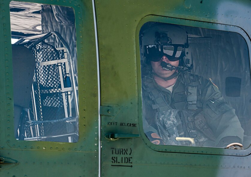 Tech. Sgt. Tim McKinley, 54th Helicopter Squadron flight engineer and Global Strike Challenge team member, prepares for takeoff during a training flight at Minot Air Force Base, N.D., Aug. 4, 2015. The 54th HS will compete against two other helicopter squadron teams, the 37th HS from Francis E. Warren AFB, Wyoming and 40th HS from Malmstrom AFB, Montana, in Air Force Global Strike Command. (U.S. Air Force photo/Senior Airman Stephanie Morris)