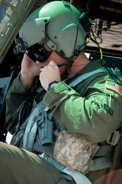 Capt. Ajay McLaughlin, 54th Helicopter Squadron pilot, adjusts his helmet before a training flight at Minot Air Force Base, N.D., Aug. 4, 2015. McLaughlin is one of six Airmen selected to represent Minot AFB for the 2015 Global Strike Challenge helicopter competition. (U.S. Air Force photo/Senior Airman Stephanie Morris)