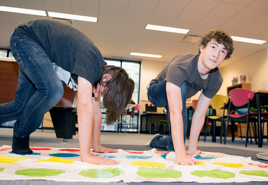 Nathaniel Venus, son of U.S. Air Force Tech. Sgt. Dustin Burgin, 23d Aircraft Maintenance Squadron, and Carter Marietti, son of Staff Sgt. Ian Marietti, 23d Equipment Maintenance Squadron, play Twister during the Back to School Bash Aug. 8, 2015, at Moody Air Force Base, Ga. Moody’s Youth Programs hosted the event to support dependents between the ages of five and 18 with youth development in fitness, recreation and education. (U.S. Air Force photo by Airman Greg Nash/Released)