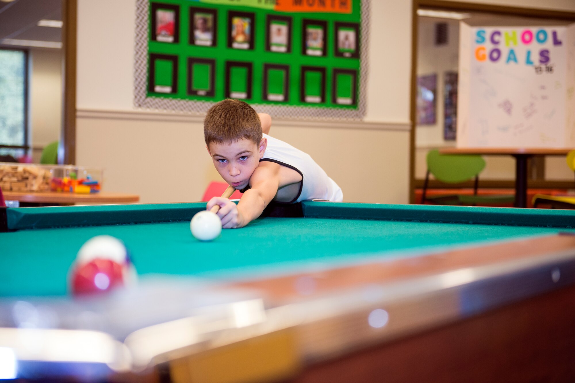 Trevan Marietti, son of U.S. Air Force Staff Sgt. Ian Marietti, 23d Equipment Maintenance Squadron, shoots pool during the Back to School Bash Aug. 8, 2015, at Moody Air Force Base, Ga. Moody’s Youth Programs hosted the event, which allowed attendees to spend their last week of summer vacation performing indoor and outdoor activities with friends as well as set school goals before the upcoming school year. (U.S. Air Force photo by Airman Greg Nash/Released) 