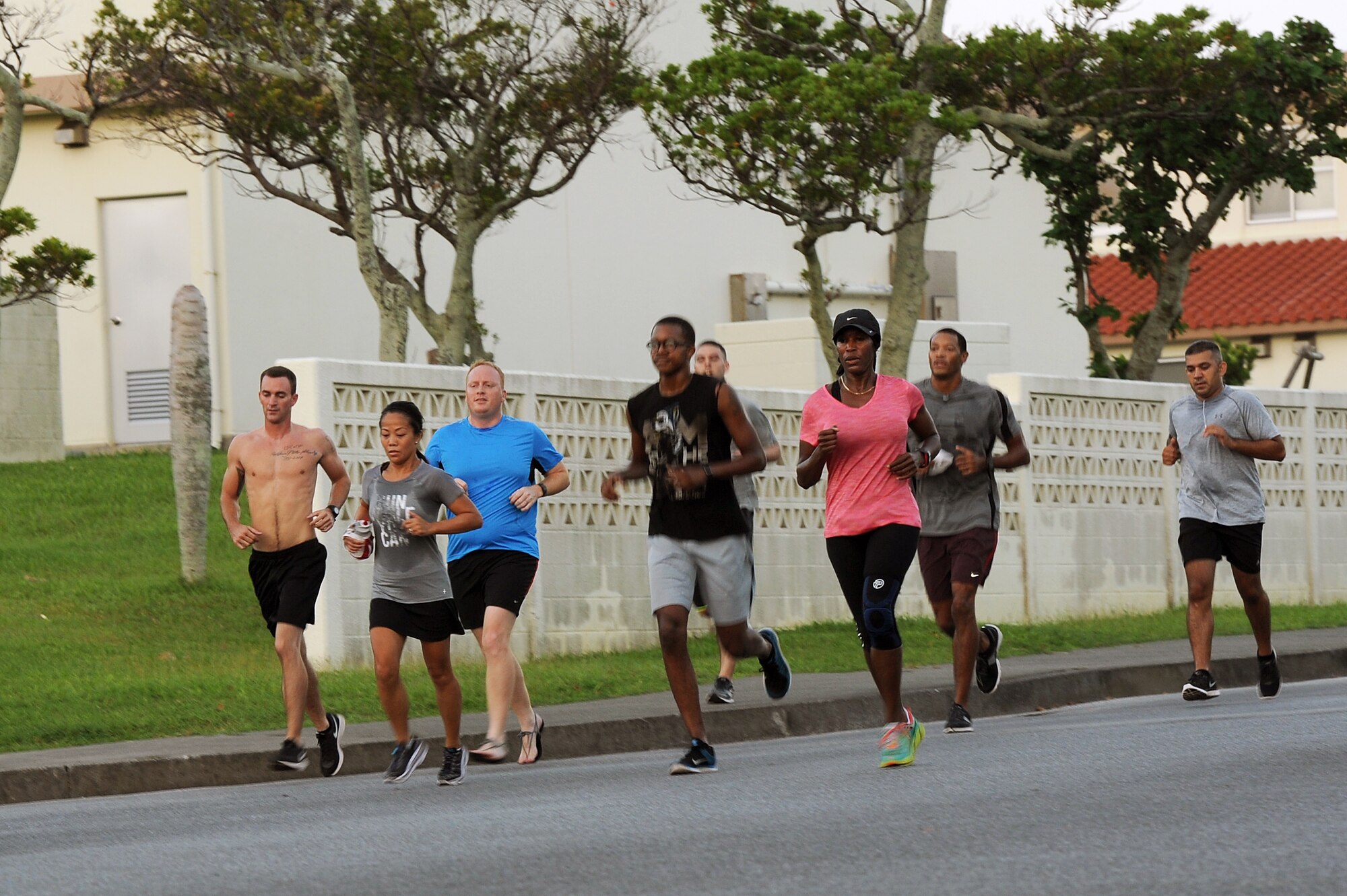 A small group from the first session of Kadena’s running improvement program finishes a light run through a neighborhood together on Kadena Air Base, Japan, Aug. 5, 2015. After an initial one-and-a-half mile timed assessment, the 136 participants were split into smaller groups by ability level, allowing those of comparable skill to push each other and help each other improve. (U.S. Air Force photo by Airman 1st Class Zade C. Vadnais)