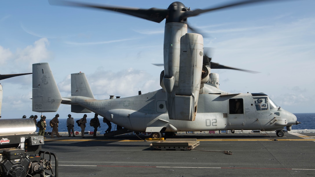 U.S. Marines and sailors with the 31st Marine Expeditionary Unit load into an MV-22B Osprey aboard the USS Bonhomme Richard, Aug. 8, 2015. The 31st MEU is staging Ospreys in Guam in support of typhoon recovery efforts in Saipan. The aircraft will be on standby in the event their aerial lift capacity is needed to distribute emergency supplies to remote areas. Saipan, the most populated island in the Commonwealth of the Northern Mariana Islands, was struck by Typhoon Soudelor Aug. 2-3. 