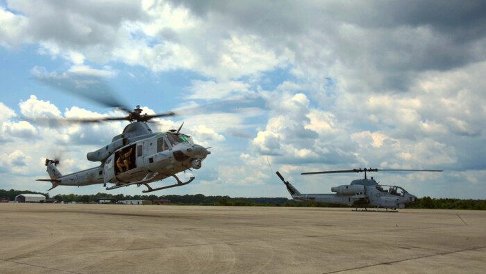 A UH-1Y Huey takes off alongside an AH-1W Super Cobra during a training exercise testing a digital interoperability system at Marine Corps Air Station Cherry Point, N.C., July 24, 2015. Digital interoperability is the technology capable of increasing prowess on the battlefield. The exercise included Marine Light Attack Helicopter Squadron 467, Marine Unmanned Aerial Vehicle Squadron 2, and U.S. Marine Corps Forces, Special Operations Command, testing a LINK 16 conversion system for one of the first times within an explicitly rotary-wing exercise.