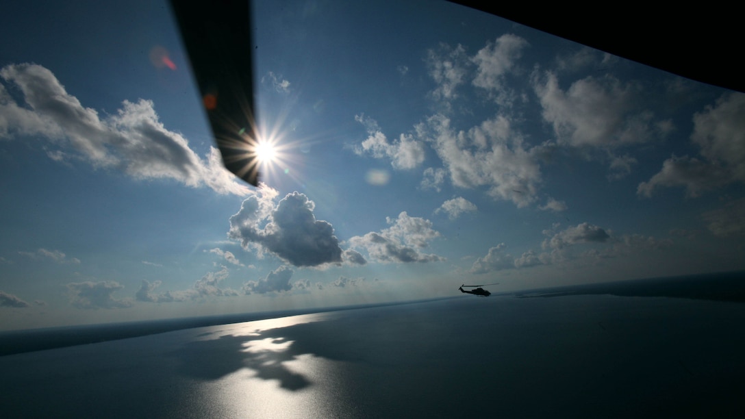 A UH-1Y Huey flies alongside an AH-1W Super Cobra during a training exercise testing a digital interoperability system at Marine Corps Air Station Cherry Point, N.C., July 24, 2015. Digital interoperability is the technology capable of increasing prowess on the battlefield. The exercise included Marine Light Attack Helicopter Squadron 467, Marine Unmanned Aerial Vehicle Squadron 2, and U.S. Marine Corps Forces, Special Operations Command, testing a LINK 16 conversion system for one of the first times within an explicitly rotary-wing exercise.