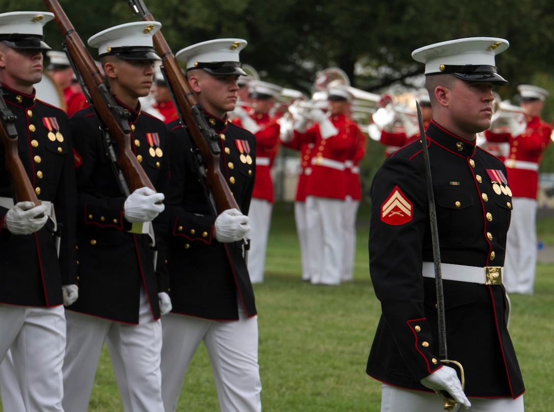 Marines with Marine Barracks Washington perform during the Sunset Parade at the Marine Corps War Memorial, Arlington, Va., Aug. 12, 2015. The hosting official for the Sunset Parade was Sgt. Maj. Ronald Green, sergeant major of the Marine Corps and the guest of honor was Hollister Petraeus, Assistant Director of the Consumer Financial. (U.S. Marine Corps photo by Cpl. Skye Davis/Released)