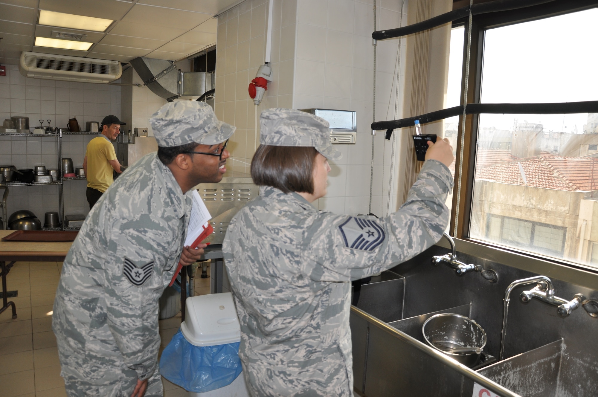 Master Sgt. Tanya Jacquez, 425th Air Base Squadron Medical Aid Station flight chief, and Tech. Sgt. Robert Wilson, 425th ABS Medical Aid Station NCO in charge, test water for chlorine levels in the Izmir Club water. (U.S. Air Force photo by Tanju Varlikli) 