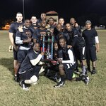 The Air Force Personnel Center flag football team holds a trophy after winning first place in the 2014 JBSA-Randolph flag football playoffs. 