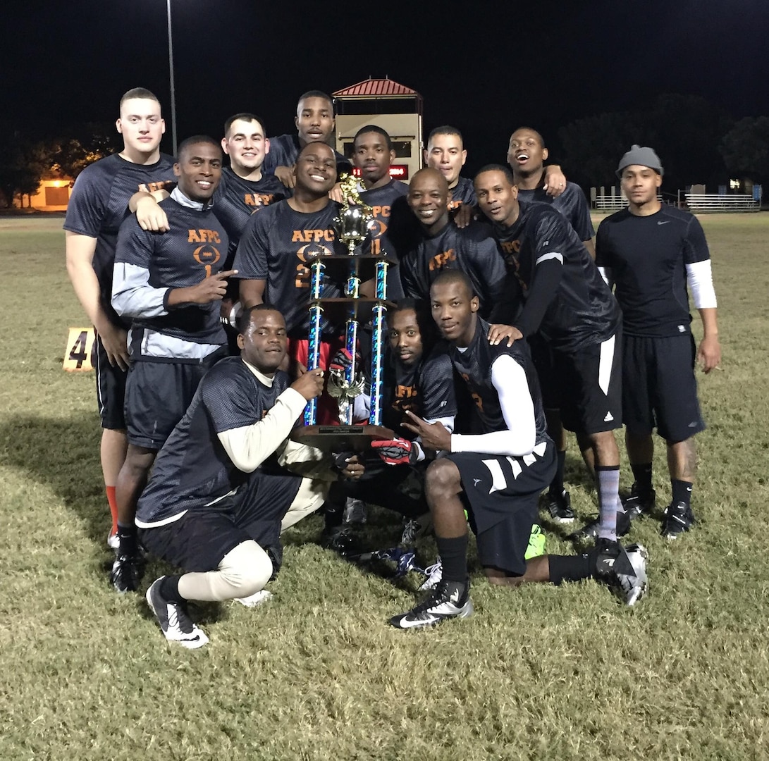 The Air Force Personnel Center flag football team holds a trophy after winning first place in the 2014 JBSA-Randolph flag football playoffs. 