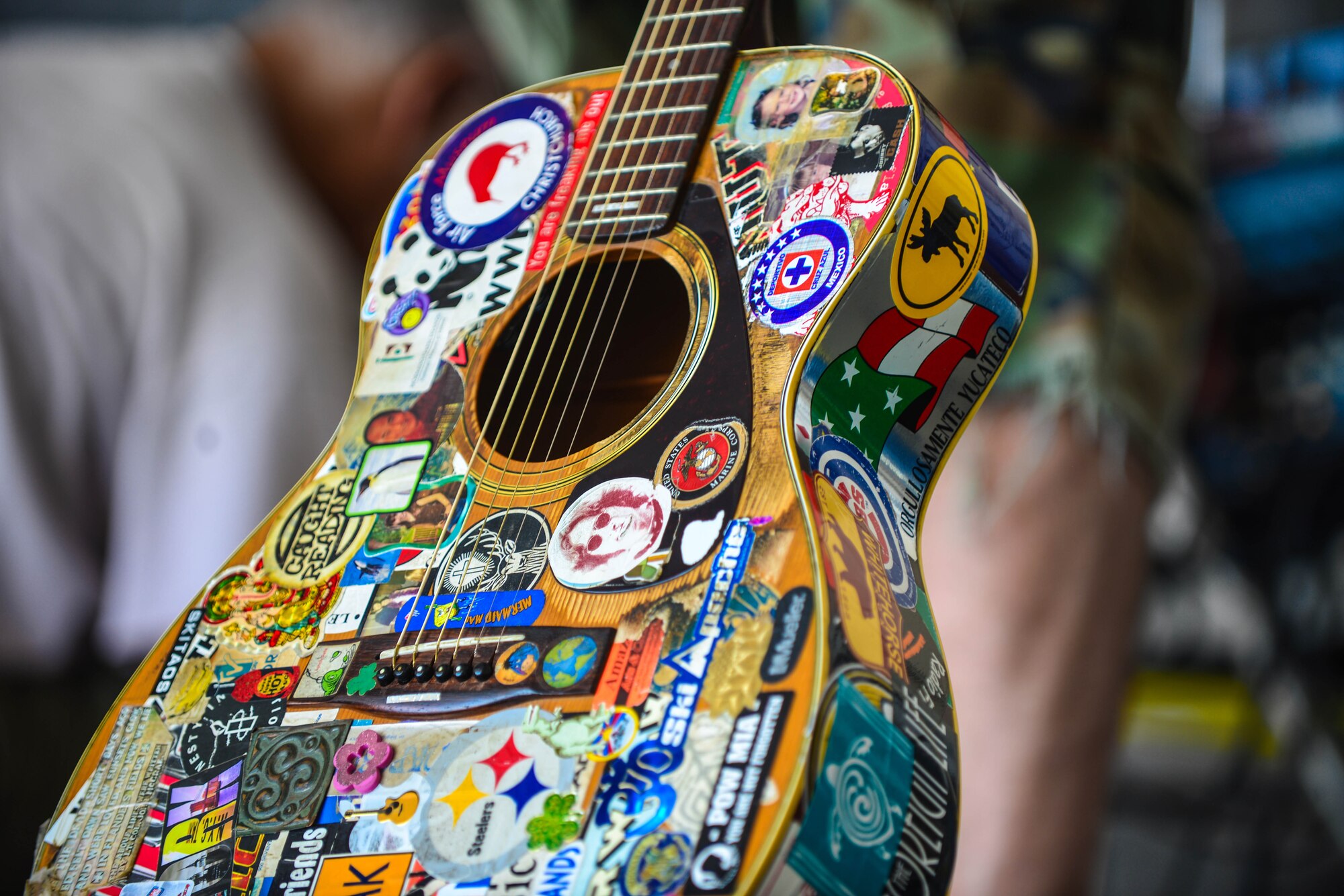 Andy Mason, a children’s performer based in Portales, N.M., prepares his guitar for a set in the “kid land” hangar at the 2015 “Rockin’ the High Planes” Open House Aug. 8, 2015 at Cannon Air Force Base, N. M.  The open house featured a showcase of many local bands. (U.S. Air Force Photo/Airman 1st Class Shelby Kay-Fantozzi) 