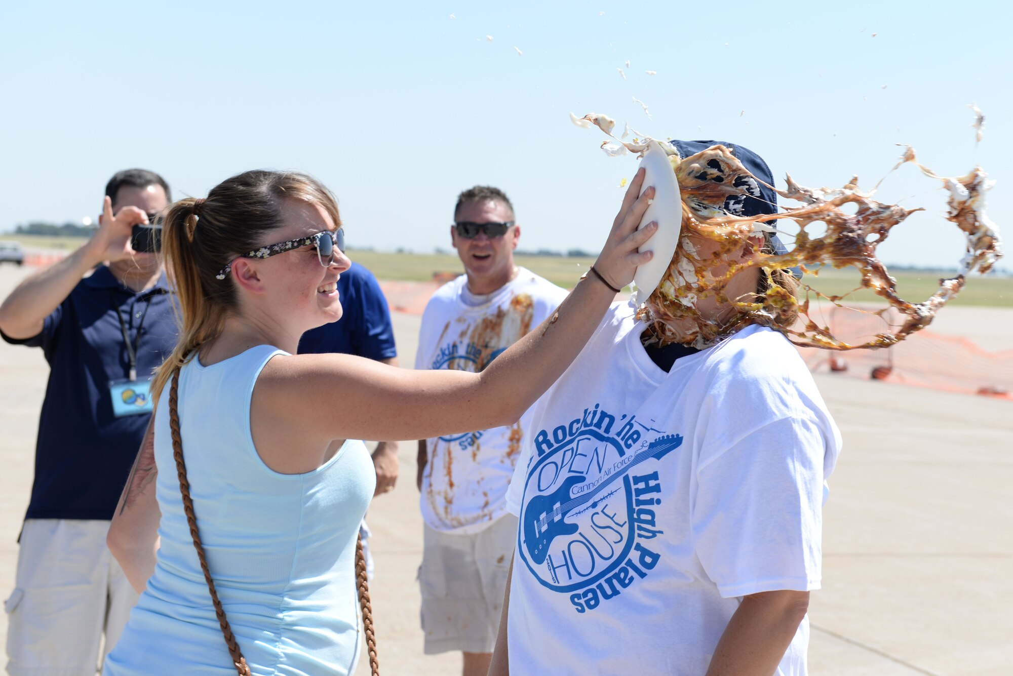 Chief Master Sgt. Sharon St. Clair, 27th Special Operations Medical Group superintendent, receives a pie in the face as part of a fundraiser during the Cannon Appreciation Day and Open House, Aug. 8, 2015 at Cannon Air Force Base, N.M. “Rockin’ the High Planes” was a free event and open to the public. (U.S. Air Force photo/Airman 1st Class Treven Cannon)