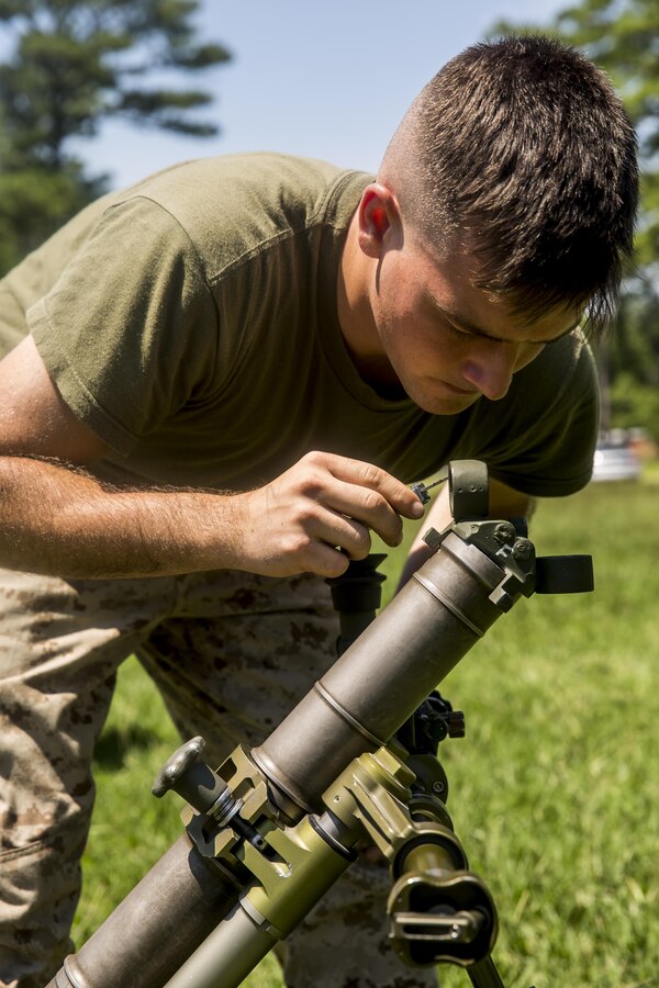 Private First Class Shawn Benoit, a mortarman with 1st Battalion, 8th Marine Regiment adjusts the sight on the M224 60 mm Mortar Lightweight Company Mortar System during a 10-day long mortar course under the direction of the Division Combat Skills Center aboard Camp Lejeune, N.C., Aug. 10, 2015. The course began with classroom instruction over the weapons system in which they learned how to boresight, misfire procedures and deflection changes for elevation before the unit moves into live-fire. (U.S. Marine Corps photo by Cpl. Krista James/Released)