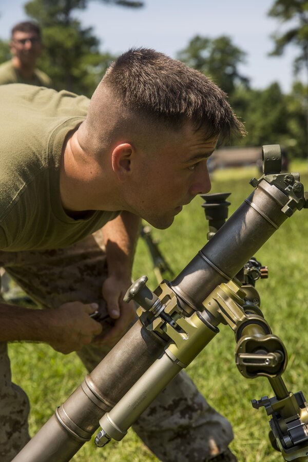 Private First Class Shawn Benoit, a mortarman with 1st Battalion, 8th Marine Regiment looks through the sight on the M224 60 mm Mortar Lightweight Company Mortar System during a 10-day long 60 mm Mortar Lightweight Company Mortar System (LCMS) course under the direction of the Division Combat Skills Center aboard Camp Lejeune, N.C., Aug. 10, 2015. The course began with classroom instruction over the weapons system in which they learned how to boresight, misfire procedures and deflection changes for elevation before the unit moves into live-fire. (U.S. Marine Corps photo by Cpl. Krista James/Released)