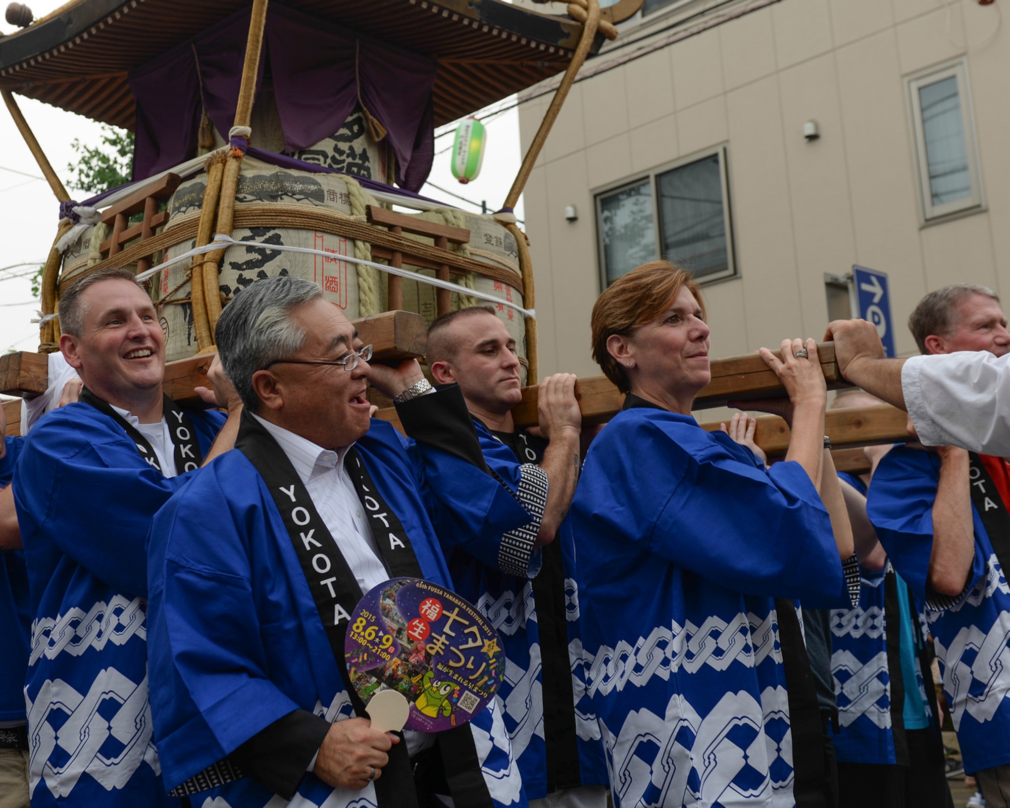 U.S. Air Force Gen. Lori Robinson, Pacific Air Forces commander, carries a mikoshi shrine with Col. Douglas DeLaMater, 374th Airlift Wing commander, and other Yokota Air Base Airmen through the street at the Tanabata festival in Fussa, Japan, Aug. 7, 2015. Robinson participated in the festival, one of Yokota’s most prominent bilateral events, as part of her visit to Yokota. (U.S. Air Force photo by Airman 1st Class Elizabeth Baker/Released)
